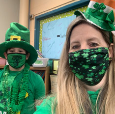Student and teacher dressed in green for St. Patricks Day