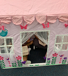 Students reading in a playhouse